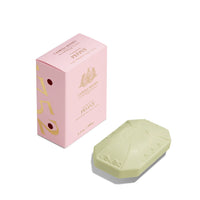 A pink box labeled "Caswell - Massey Peony Luxury Bar Soap 100gm" next to a light green, triple-milled soap embossed with a floral design, against a white background.