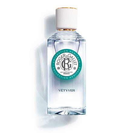 A clear glass bottle of Roger & Gallet Vetyver - Wellbeing Fragrant Water - 3.3 oz by Roger & Gallet, Paris. The bottle has a gold cap and a label with green and white accents on a white background.