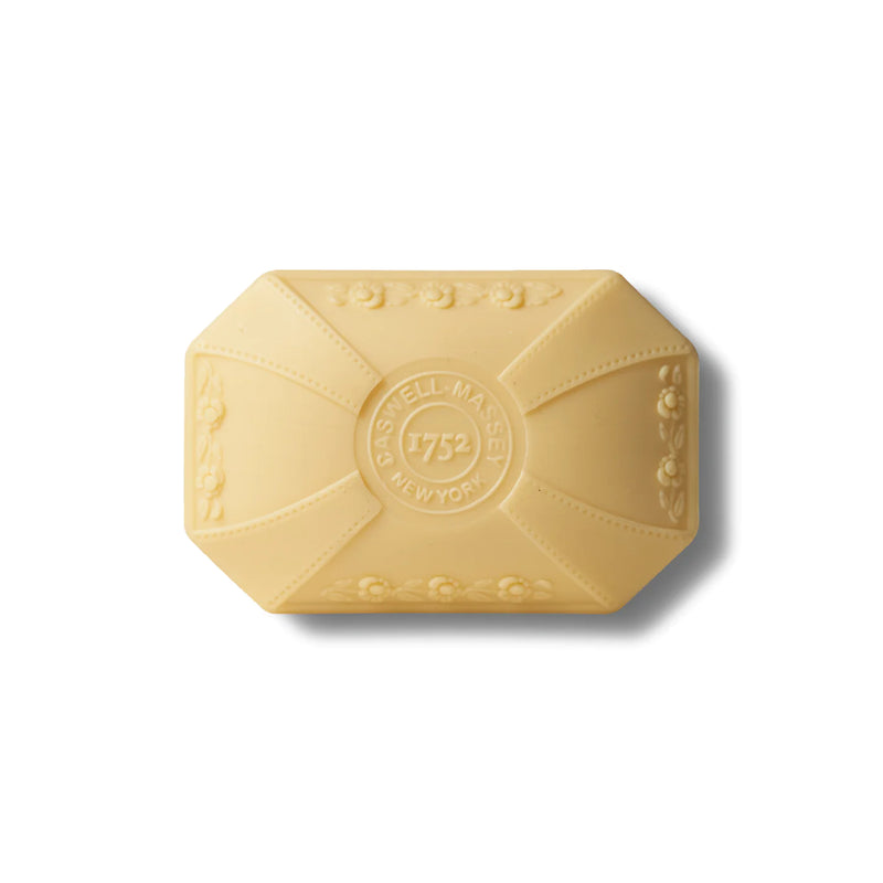 A bar of yellow, triple-milled Caswell - Massey Marem Luxury Bar Soap 100gm with an embossed logo reading "Caswell-Massey 1752 New York," shaped with ornate detailing around the edges, isolated on a white.
