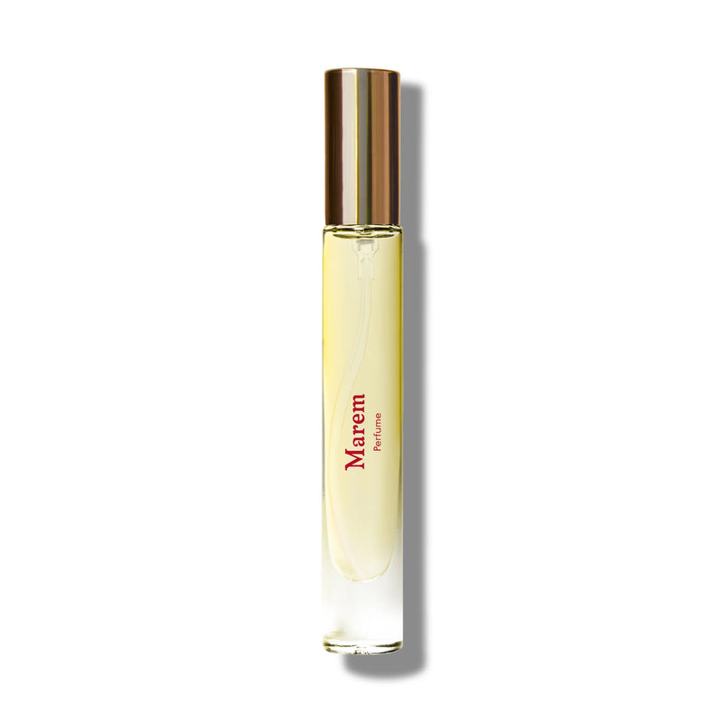 A slim, clear Caswell Massey Marem perfume roller bottle with a golden cap, filled with yellow liquid. The label reads "Caswell Massey Marem" in stylized red font with "amber creme" beneath.