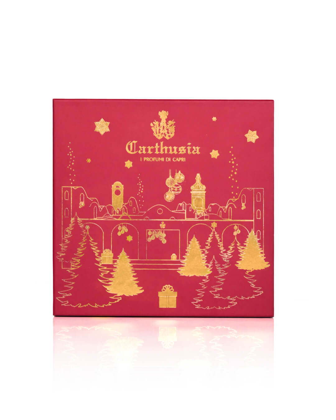 A red holiday-themed luxury Carthusia Christmas Villa Jovis – Fiori di Capri gift box featuring gold illustrations of Christmas trees, gifts, and festive decorations, with the Carthusia I Profumi de Capri brand name prominently displayed.