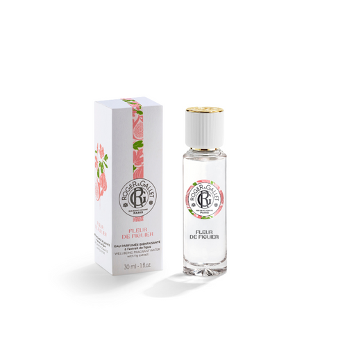 A clear glass bottle of Roger & Gallet Fig Blossom fragrant water next to its floral-printed white box on a white background.