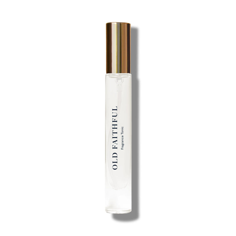 A clear glass rollerball perfume bottle with a golden cap, labeled "Caswell - Massey Yellowstone Old Faithful Fragrance Tonic - 7ml" on a plain white background.