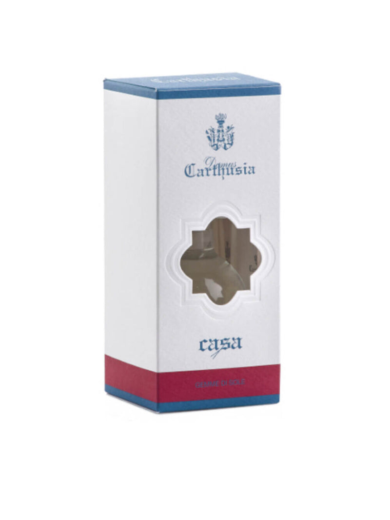 A box of Carthusia I Profumi de Capri Gemme di Sole Reed Diffuser 100ml with a transparent window displaying a brown product inside. The box is white with blue and red accents and elegant script text.