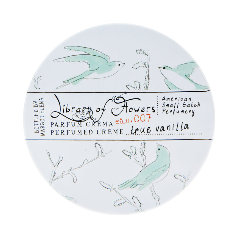 Round container of Margot Elena's Library of Flowers True Vanilla Parfum Crema featuring delicate illustrations of birds and floral elements on a white background, with text detailing the product scent as true vanilla. This triple-scented cream ensures a