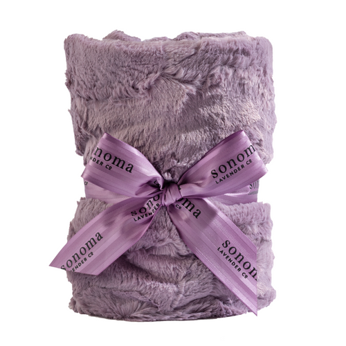A stack of Sonoma Lavender Elderberry Heat Wraps tied with a decorative ribbon labeled "Sonoma" against a white background, ideal for aromatherapy relief.