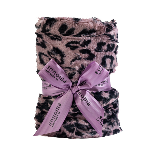 A plush jaguar print heat wrap neatly folded and tied with a violet ribbon labeled "Sonoma Lavender" against a white background.