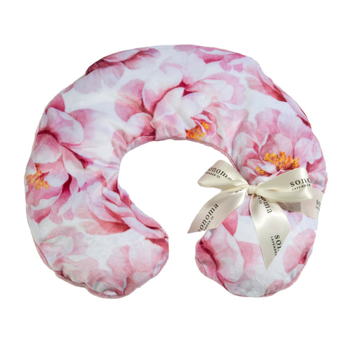 A floral pattern neck pillow in pink and white, adorned with a bow and featuring a label that reads "Sonoma Lavender Muscle Relief Pillow." - A Sonoma Lavender Rose Bloom Neck Pillow in pink and white, adorned with a bow and featuring a label that reads "Sonoma Lavender Muscle Relief Pillow.