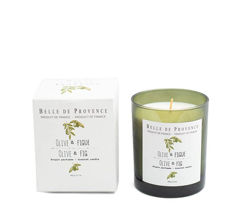 A Lothantique Belle de Provence Olive & Fig 190g Scented Candle is shown next to its box. The candle, crafted from vegetable wax, is housed in a green glass container with a white label that reads "Olive & Fig." The sleek white box features similar text and an illustration of olive branches, evoking herbal fragrances.