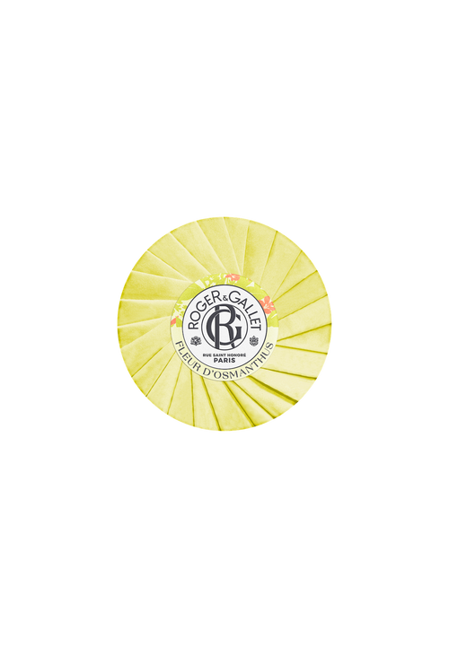 A round, yellow cheese wheel branded with "Roger & Gallet" and infused with osmanthus on its rind, isolated against a black background.