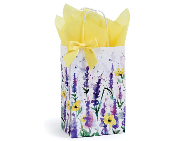 A Nashville Wraps gift bag adorned with a watercolor lavender pattern in shades of purple and yellow, featuring a yellow ribbon and filled with yellow tissue paper.