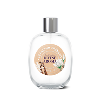 A clear glass Le Parfum Français Divine Aroma Eau de Toilette 100ml bottle with a silver cap. The label features elegant typography and illustrations of green leaves and brown branches, embellished with the text "Eau de toilette, Divine Aroma".