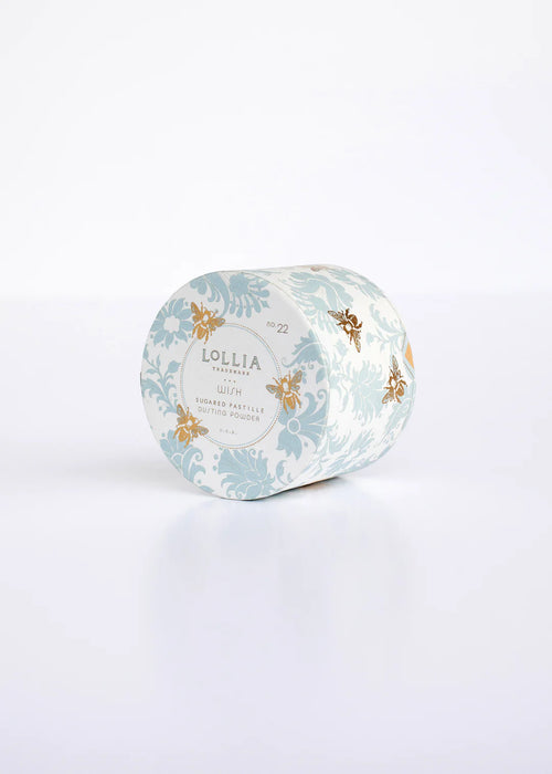 A Margot Elena brand Lollia Wish Dusting Powder - Mini! with a Sugared Pastille and gold design on light blue packaging displayed against a white background.
