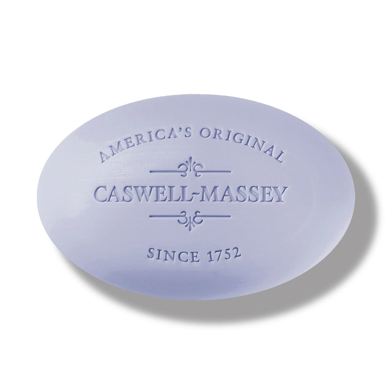 An oval-shaped, white Caswell - Massey Centuries Lavender Bar Soap with embossed text that reads "america's original Caswell Massey since 1752" on a light gray background.