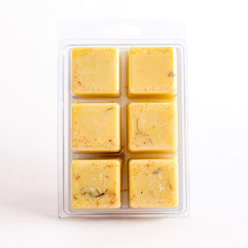 Six squares of frozen SOAK Bath Co. Cocoa Butter Bath Melt desserts infused with sweet almond oil in a clear plastic package with a white background, each piece neatly arranged in two rows.
