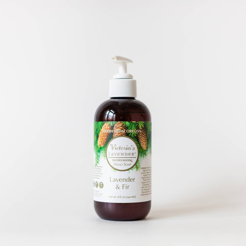 A brown bottle of Victoria's Lavender - Lavender & Fir Liquid Hand Wash with a pump dispenser, featuring an illustrated label of green fir branches and purple lavender flowers on a white background.