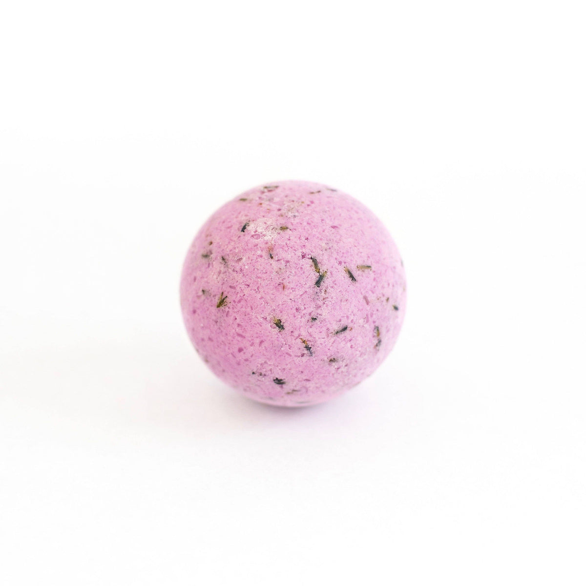 A SOAK Bath Co. Lavender Bath Bomb with specks of black and green, placed centrally on a plain white background.
