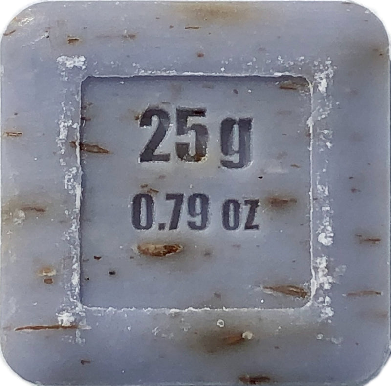 Close-up of a frost-covered La Lavande Lavender Flower Guest Soap 25gm label displaying weight measurements, reading "25g" and "0.79 oz," embedded on a textured, icy surface.