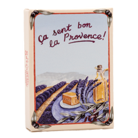 Decorative tile featuring an illustration of a lavender field in Provence, with a caption in French saying "ça sent bon la Provence!" There are images of a bottle of La Savonnerie de Nyons Provence Lavande 25gm Soap in Paper Box.