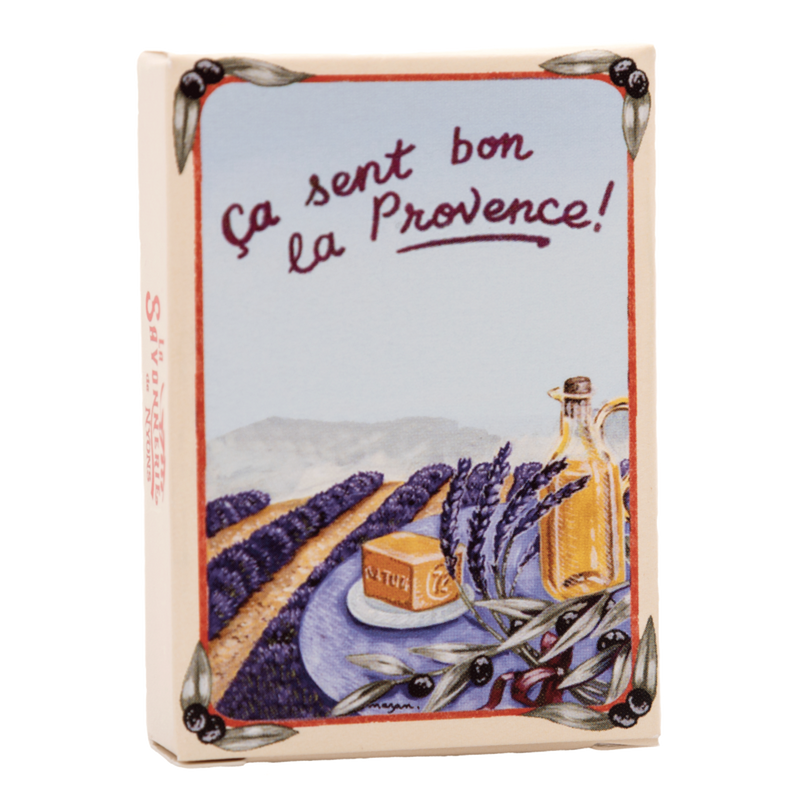 Decorative tile featuring the phrase "ça sent bon la Provence!" with illustrated lavender fields, a La Savonnerie de Nyons Provence Lavande 25gm Soap in Paper Box, and olives, evoking the essence of Provence, France.
