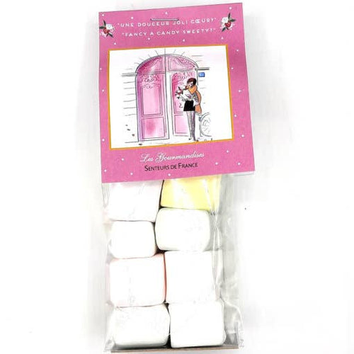 A pack of Senteurs de France traditional marshmallow candy jewelry featuring pastel-colored, pillow-shaped sweets in a transparent wrapper, with an illustration of a girl in a pink Parisian setting on the label.