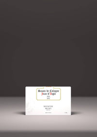 A vintage-style soap package, labeled "Jean d'Aigle Rose Soap" by Jean d'Aigle, highlighted by a spotlight, placed centrally against a grey background.