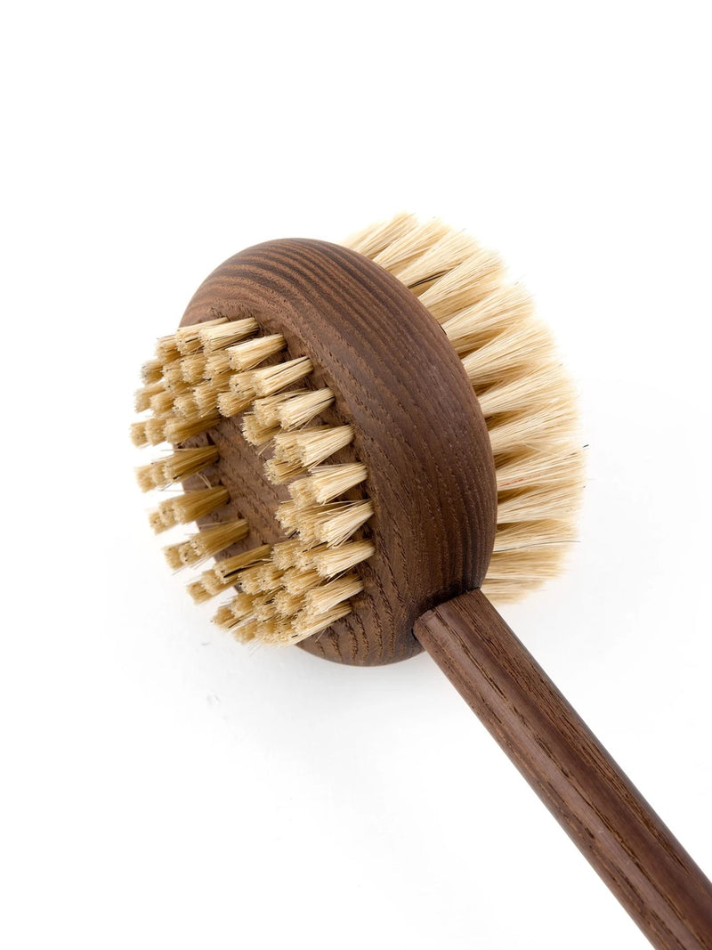A Andrée Jardin Heritage Ash Wood Handled Body Brush with natural bristles, viewed from an angle that highlights both the handle and the brush head, against a stark white background.
