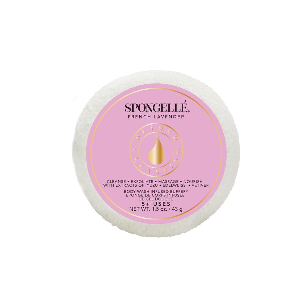 A round, white exfoliating sponge labeled "Spongellé - Travel Size Spongette French Lavender" is infused with a soothing lavender scent. The label is pink and details the sponge's features and uses, highlighting.