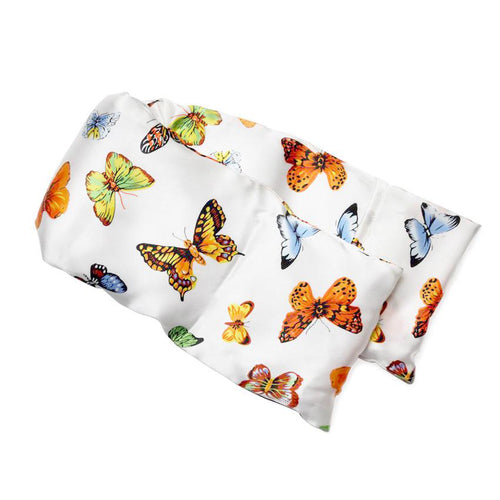 A piece of white fabric adorned with colorful printed butterflies in various shades and patterns, draped elegantly over a plain white background, featuring an integrated elizabeth W Silk Hot/Cold Flaxseed Pack filled with flaxseed for therapeutic purposes.