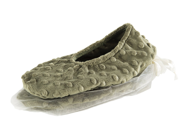 A single olive green Sonoma Lavender fleece slipper with a fluffy texture and a decorative white bow, presented on clear plastic wrapping, isolated on a white background. Now featuring Sonoma Eucalyptus Lavender Spa Green Dot Spa Footies.