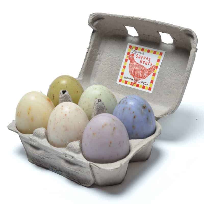 A La Lavande egg carton of six speckled egg soaps in pastel shades of yellow, green, blue, and purple, labeled "sarah's dens french free-range eggs.