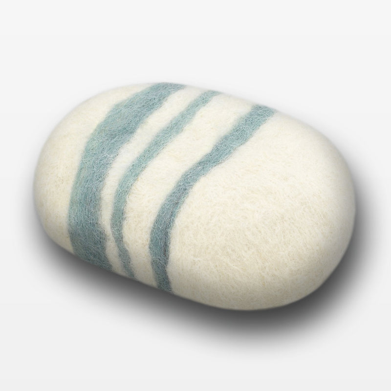 A smooth, oval-shaped Fiat Luxe - Striped Lavender - Sage felted soap with three light blue stripes wrapped around its creamy white surface, featuring natural anti-fungal properties, positioned against a white background.
