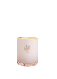 A Lollia Always in Rose No. 39 Perfumed Luminary Candle with a gold interior and a cross design on the front by Margot Elena.