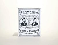 Vintage advertisement for "Penn Chemists," featuring portraits of two men and text promoting special oils, candles, cures, and remedies including Penn Chemists Classic Candle - Black Gardenia. The design is detailed and monochrome.
