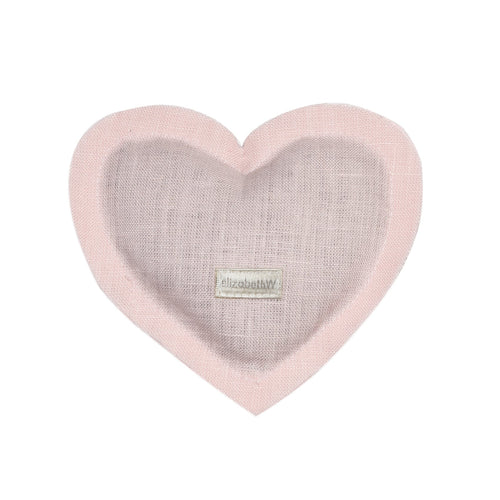 Heart-shaped baby blanket in pink and gray with a small name tag labeled "elizabeth" visible on the elizabeth W Linen Heart Sachet - Pink, carrying a subtle herbal aroma.