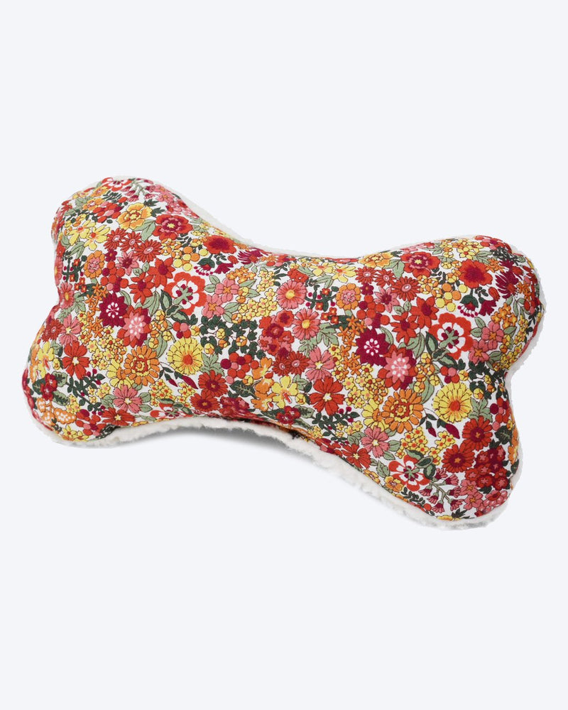 A decorative MODERNBEAST Lavender Zenbone-shaped pillow with a vibrant floral pattern in red, orange, and yellow hues on a white background.