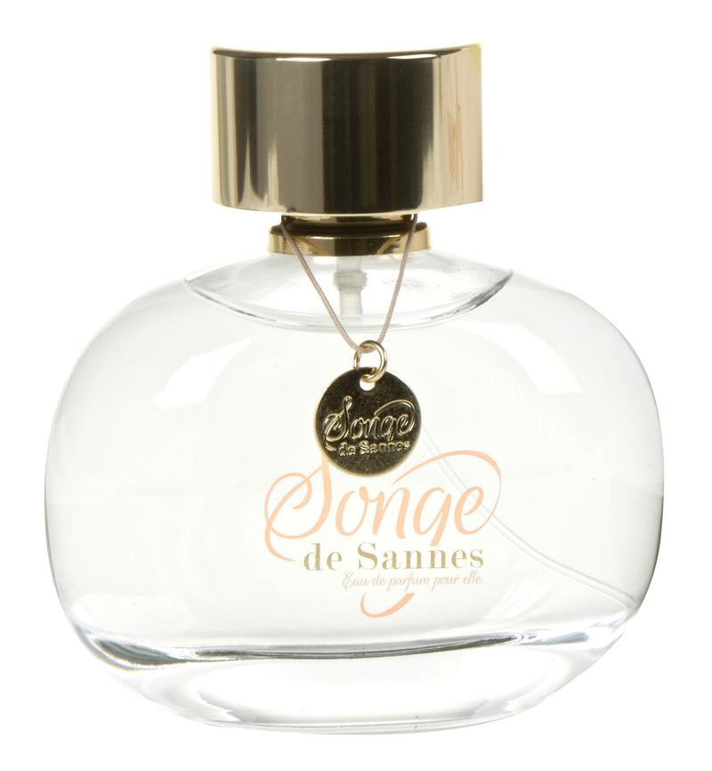 A clear, round Chateau De Sannes Eau de Parfum bottle with a gold cap. There's a pendant labeled "Songe de Sannes" hanging from the neck and the same text is printed in elegant.