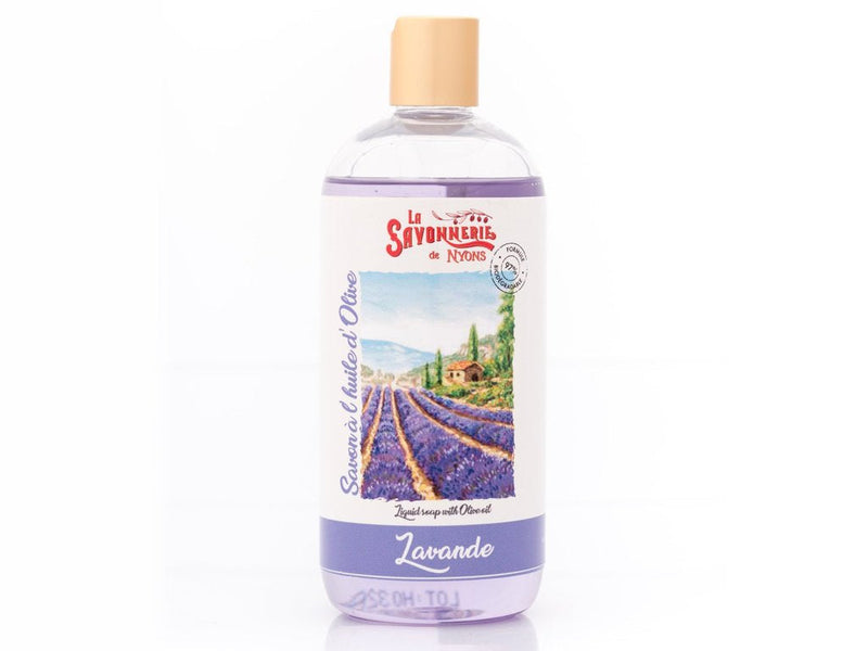A plastic bottle of La Savonnerie de Nyons Lavender Liquid Soap Refill featuring a label with a picturesque lavender field in Provence and a quaint village. The cap is gold-colored, and the soap is light violet.