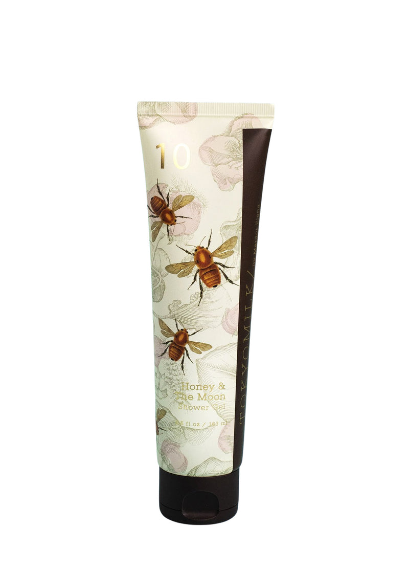A tube of TokyoMilk Honey & The Moon No. 10 Shower Gel by Margot Elena, featuring a floral and bee print design with a sudsy formulation, isolated on a white background.