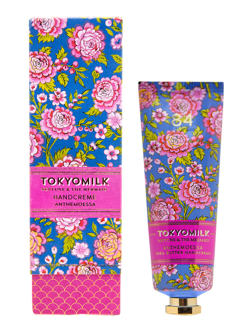 A vibrant floral-patterned Margot Elena TokyoMilk Neptune & The Mermaid Anthemoessa NO. 84 Shea Butter Handcreme in a tube, next to its matching decorative box. The packaging features pink and blue flowers with golden accents.