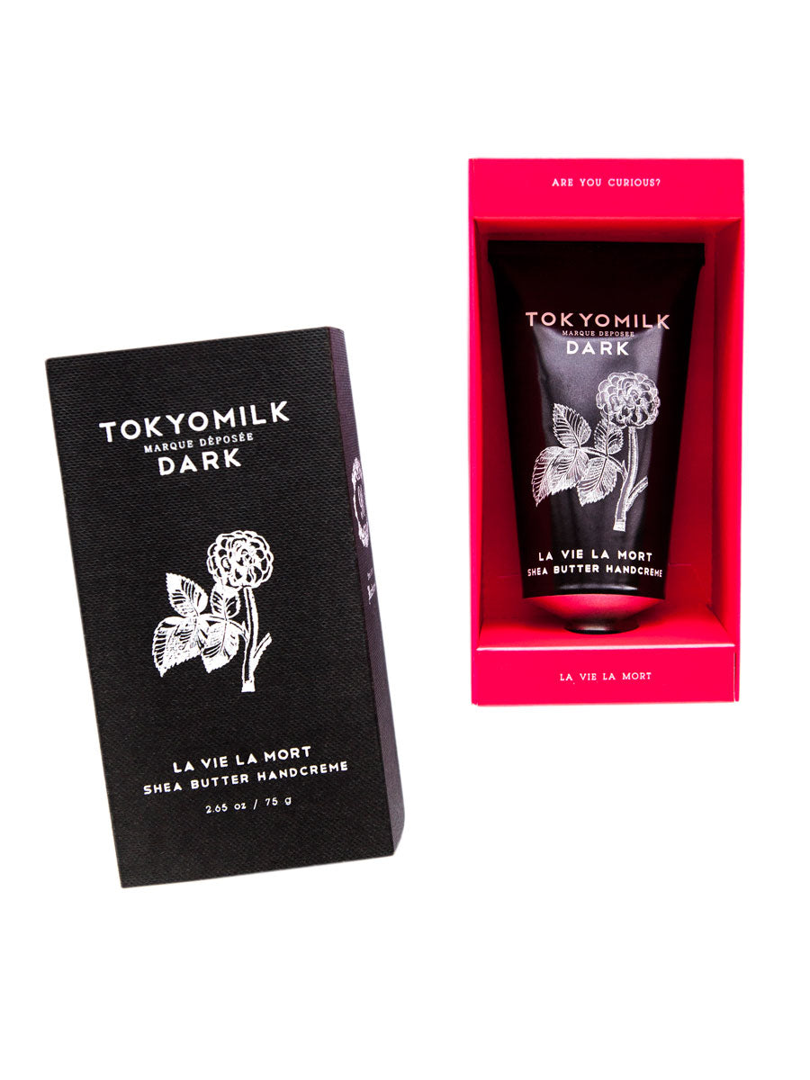 Two Margot Elena TokyoMilk Dark La Vie La Mort Handcreme products displayed against a white background: on the left, a closed black box labeled "La Vie La Mort" and on the right, a red box with an opened flap.