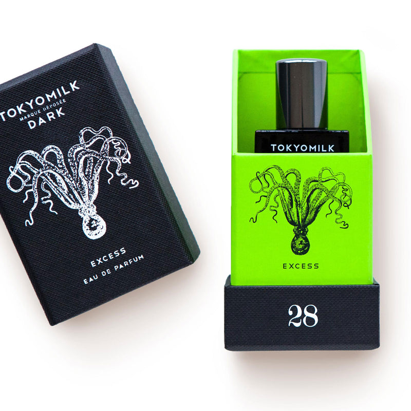 Two Margot Elena TokyoMilk Dark Excess No. 28 Eau de Parfum packages: the left is black with a white jellyfish illustration; the right features a bright lime background with amber resin accents, both showcasing eau de par.
