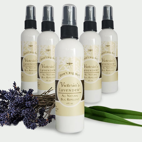 Five bottles of Victoria's Lavender  “Don’t Bug Me” all-natural mosquito repellent spray arranged in a semicircle with a bouquet of lavender in front.