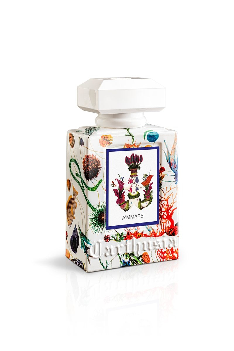 A bottle of Carthusia A'mmare Eau de Parfum 50ml fragrance with a colorful botanical design, featuring a variety of flowers and plants, on a white background from Carthusia I Profumi de Capri.