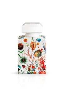 A Carthusia A'mmare Eau de Parfum 50ml bottle with a white cap and a vibrant Capri garden and floral print on the body, against a white background.