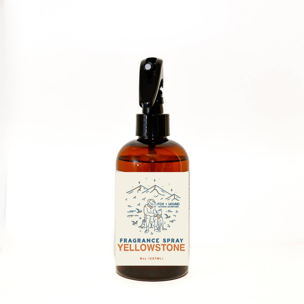 A bottle of "Fox + Hound Yellowstone Spray Cologne For Dogs National Park series" with a pump spray top, featuring nature-themed artwork on the label, set against a plain white background.