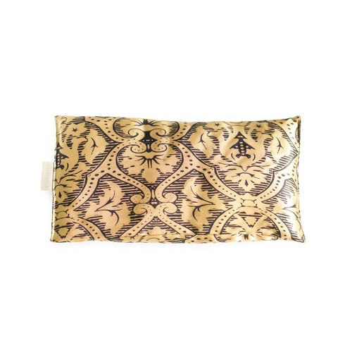 Decorative Elizabeth W Silk Eye Pillow with an intricate black, gold, and white Damask pattern, isolated on a white background.