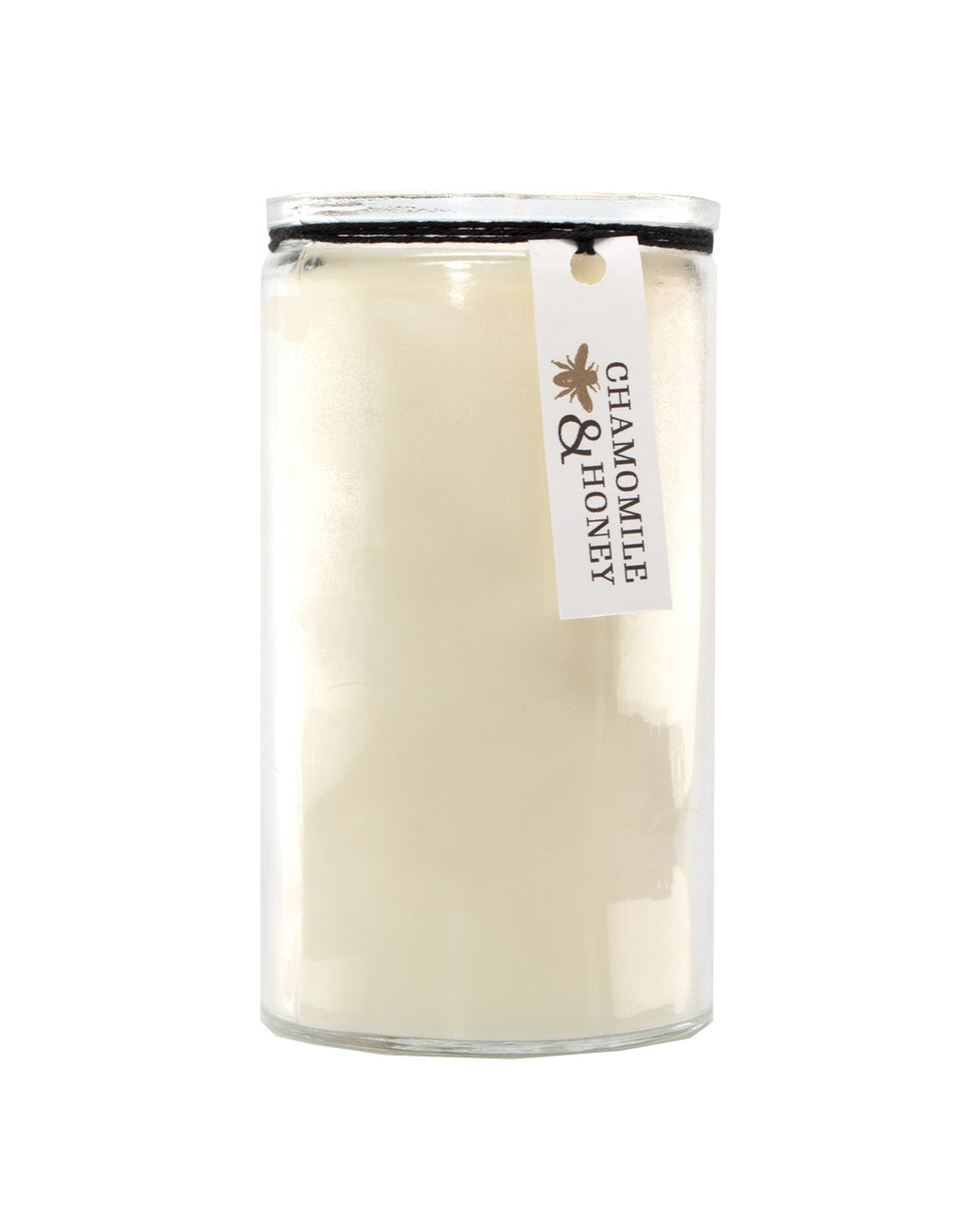 A large U.S. Apothecary Chamomile & Honey Candle in a clear glass jar with a beige label featuring the text "chamomile & honey" attached by a brown string. The candle wax is made of soy vegetable wax.