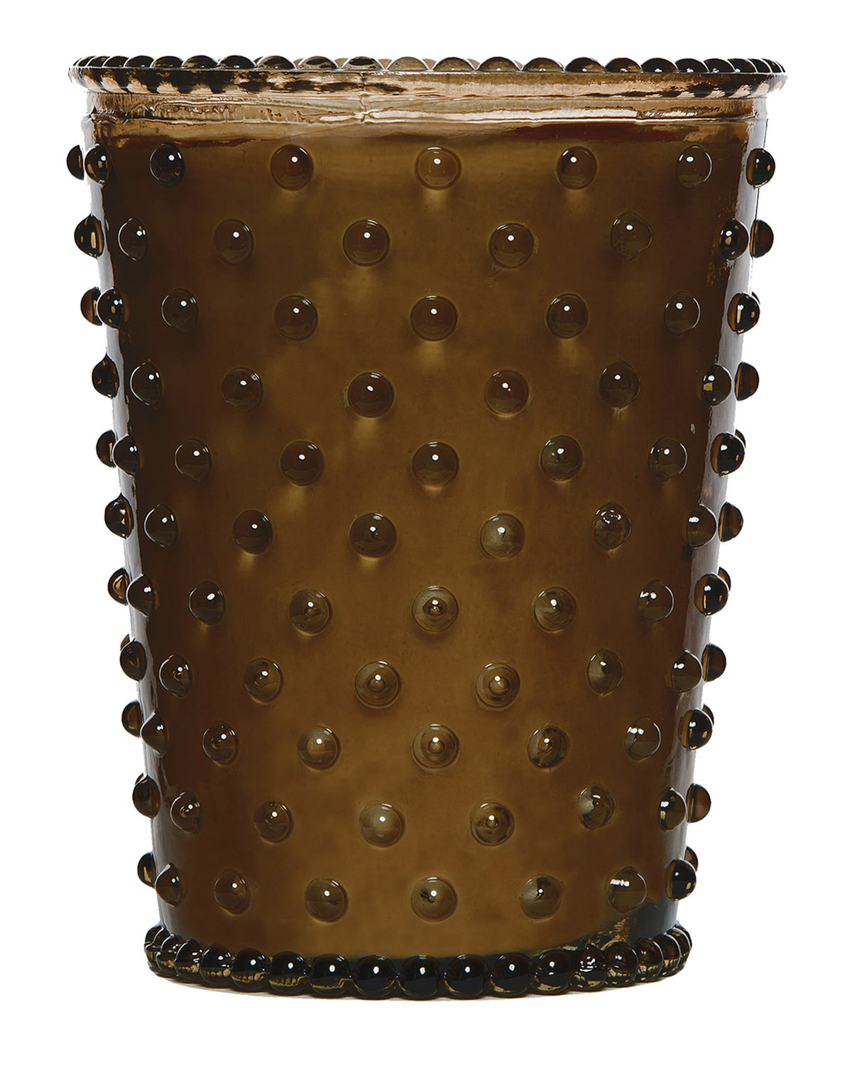 A close-up of a studded, translucent Simpatico NO. 86 Cocoa Almond Hobnail Glass Candle in a disposable cup, topped with foam and sealed with a clear plastic film.