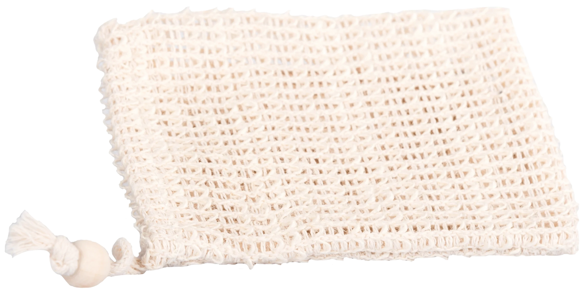 A beige textured exfoliating bath sponge folded neatly with a La Savonnerie de Nyons Cotton Soap Pocket on its left, against a white background with a soft shadow underneath.